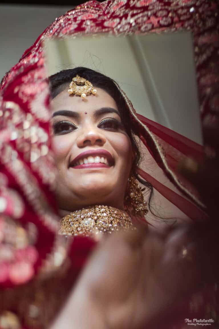 north indian bride looking in a mirror